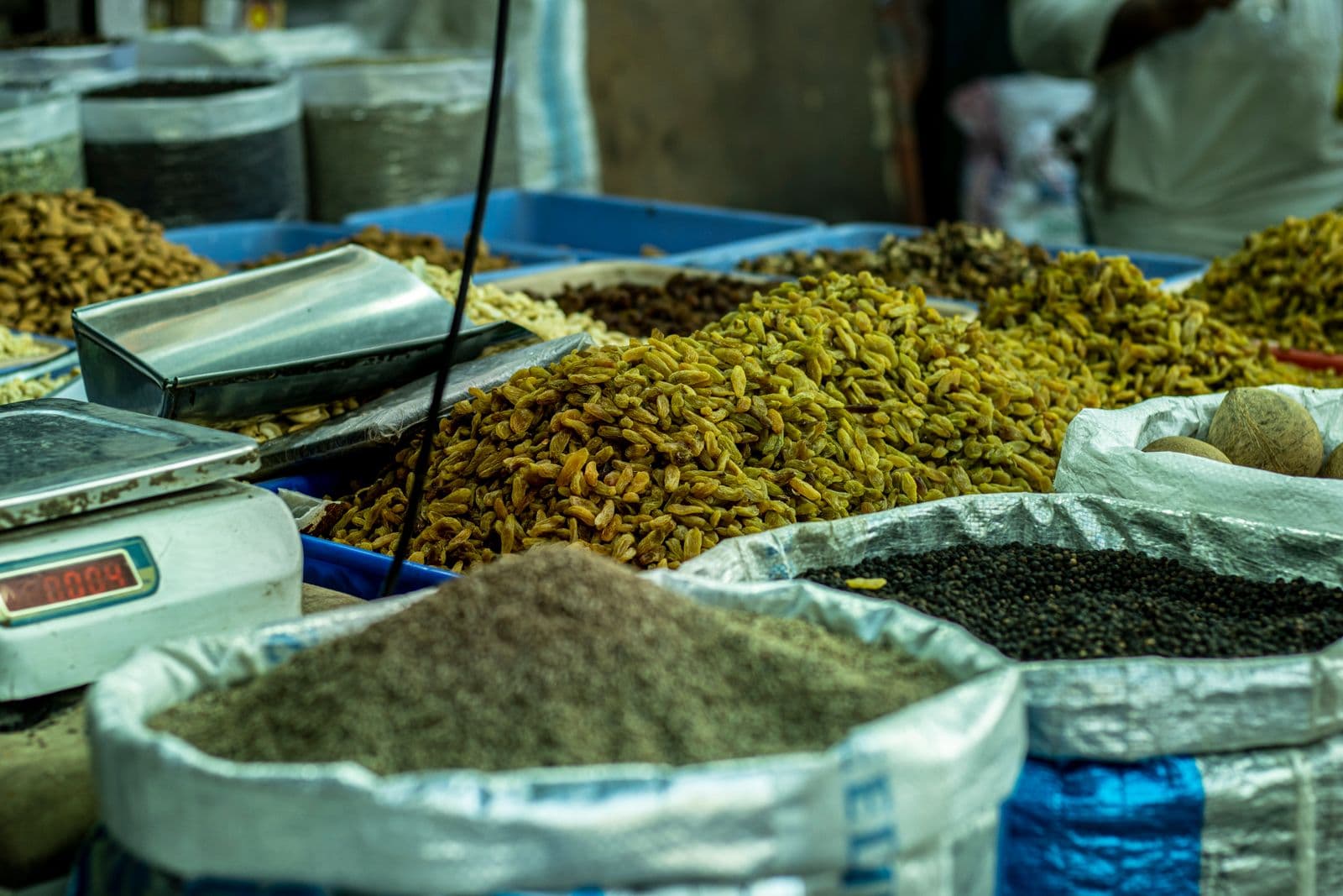Grain sacks and fresh produce at a market stall in India