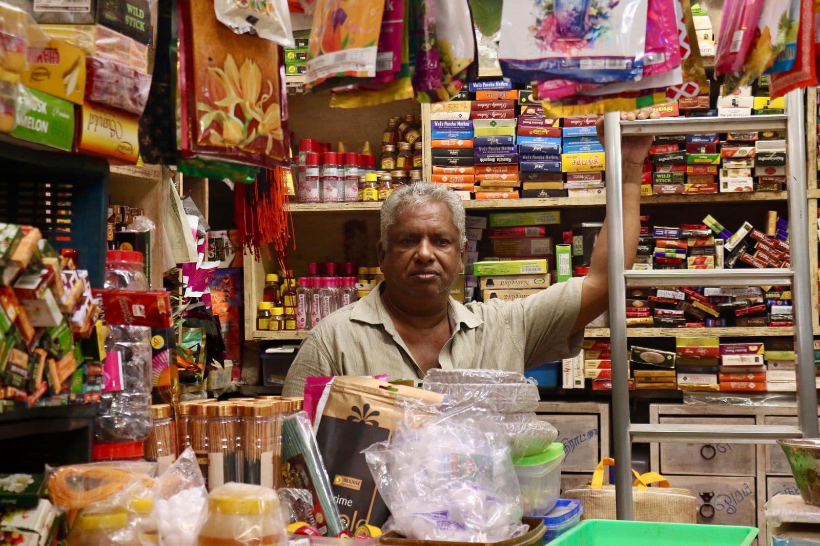 Grocery kirana store owner behind the counter of the shop