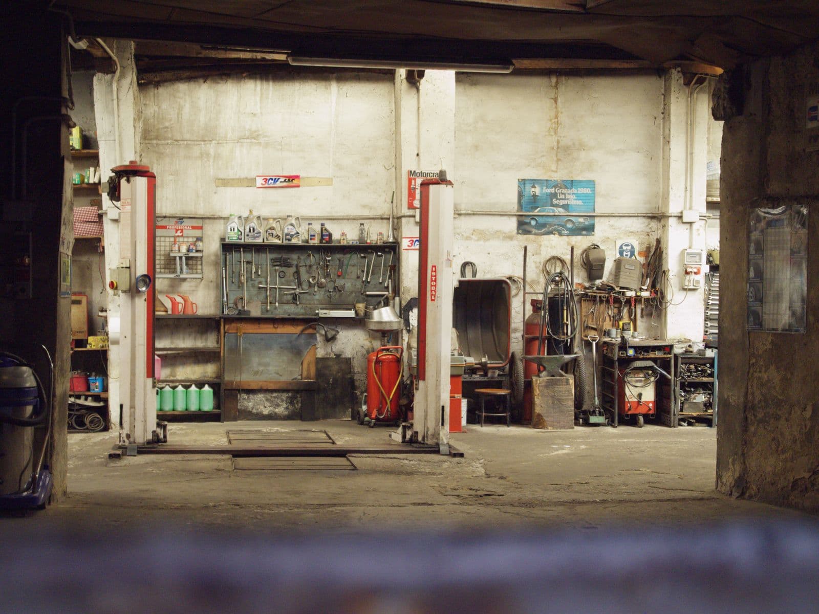 Auto garage tools and a car in a repair workshop