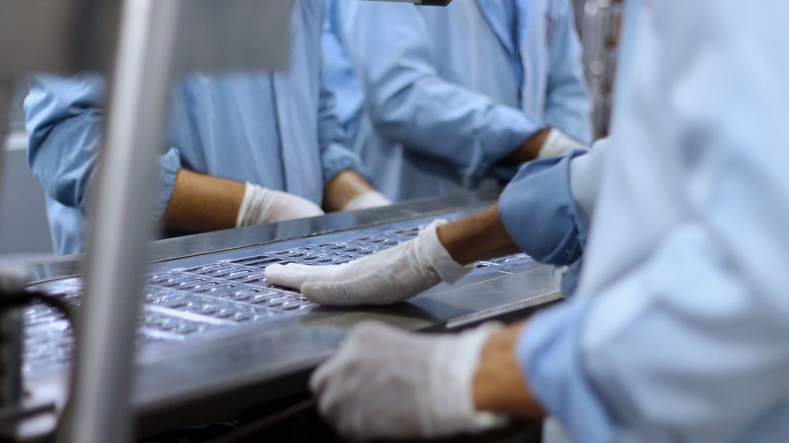 Factory manager using a tablet beside a production line