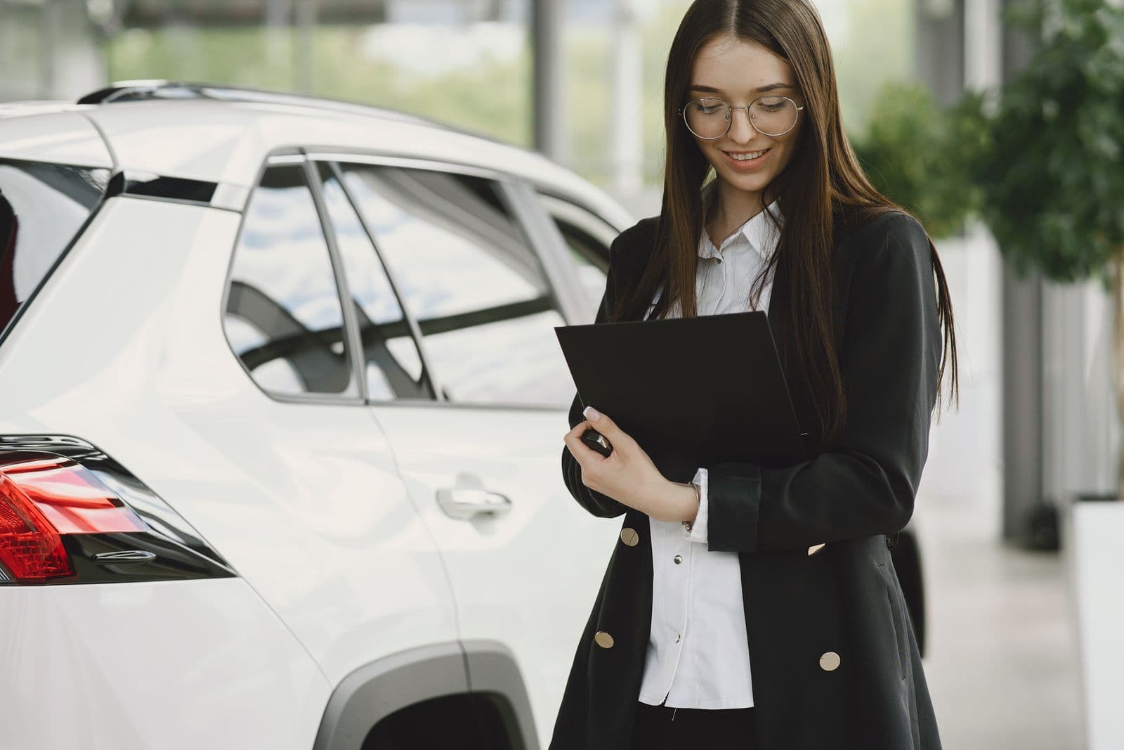 Car dealership paperwork and documents on an office desk