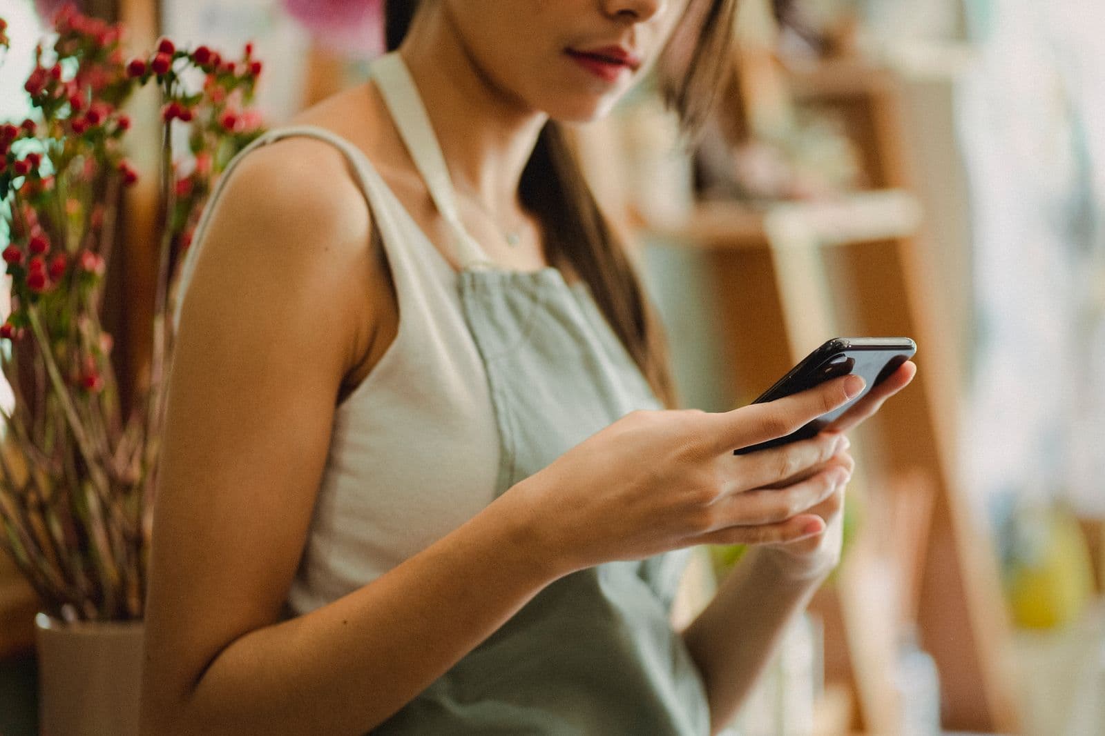 Business owner sharing a WhatsApp catalogue with customers from their shop