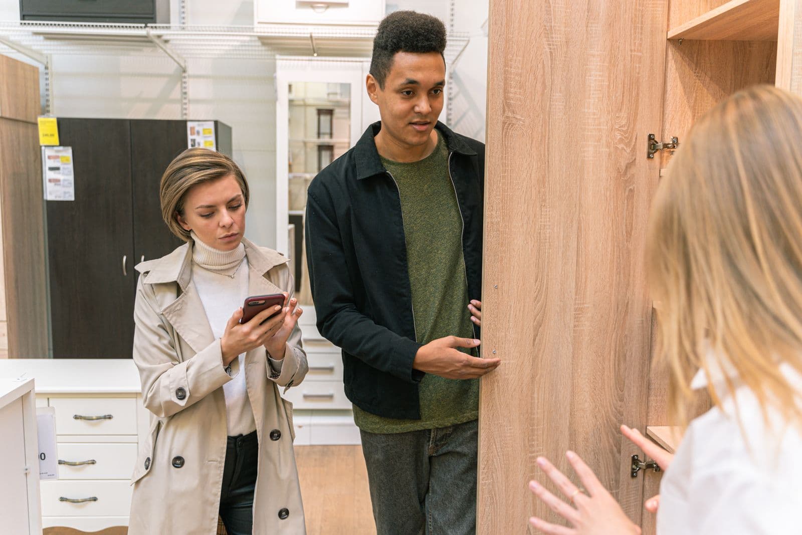 Shop owner showing a designed product catalogue on a phone to a customer