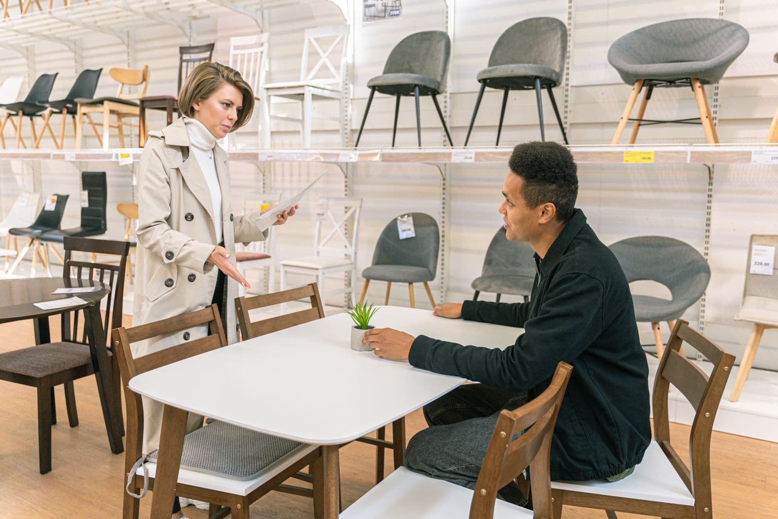 Furniture store owner with a customer in a showroom