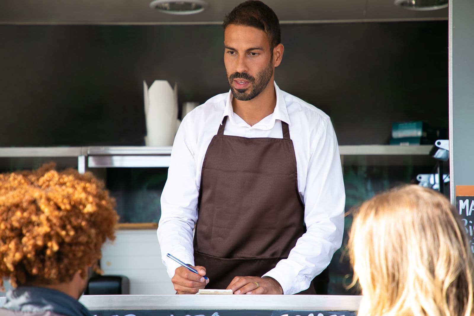 Business owner talking with a customer at a counter