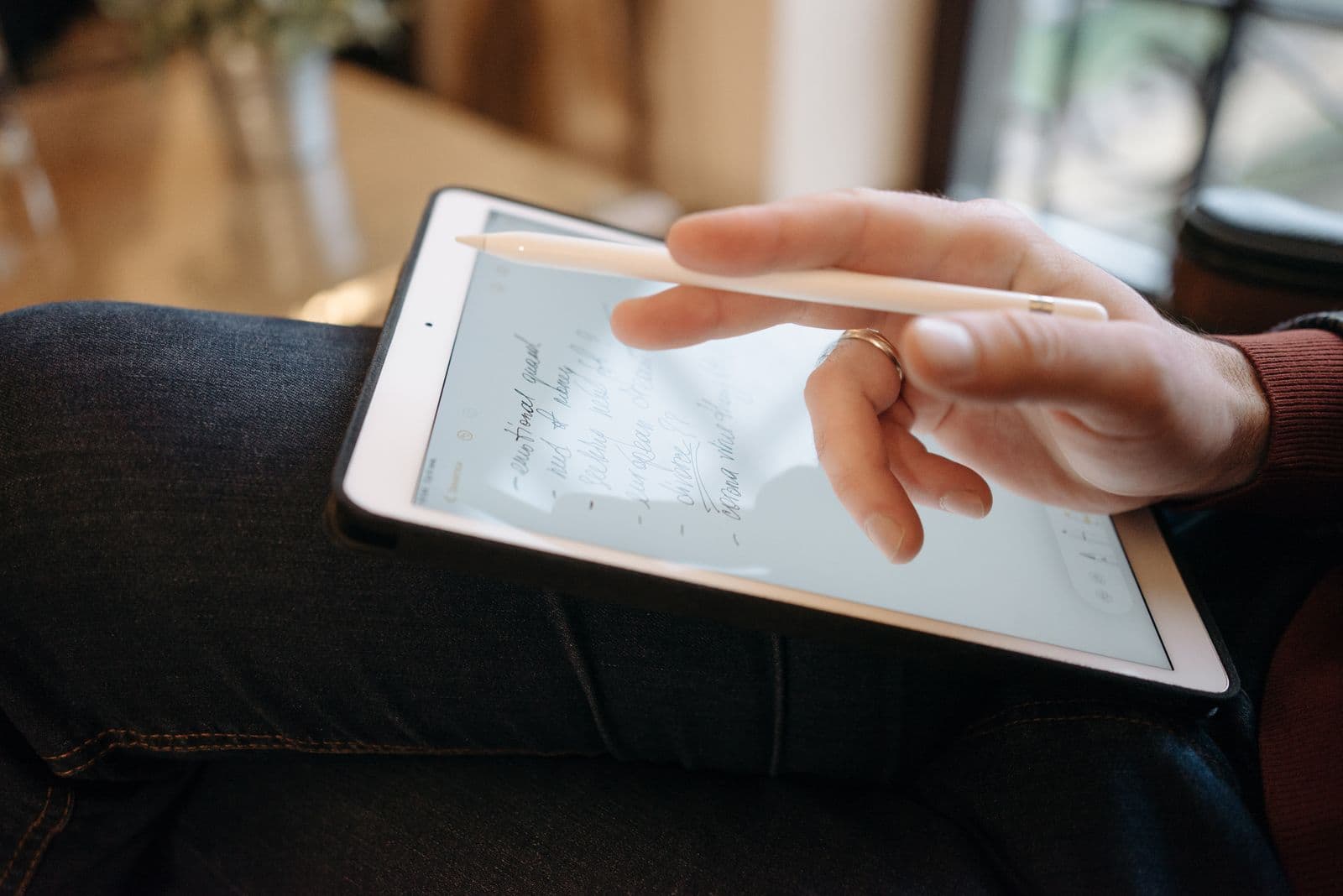Professional working in a modern paperless office with a tablet
