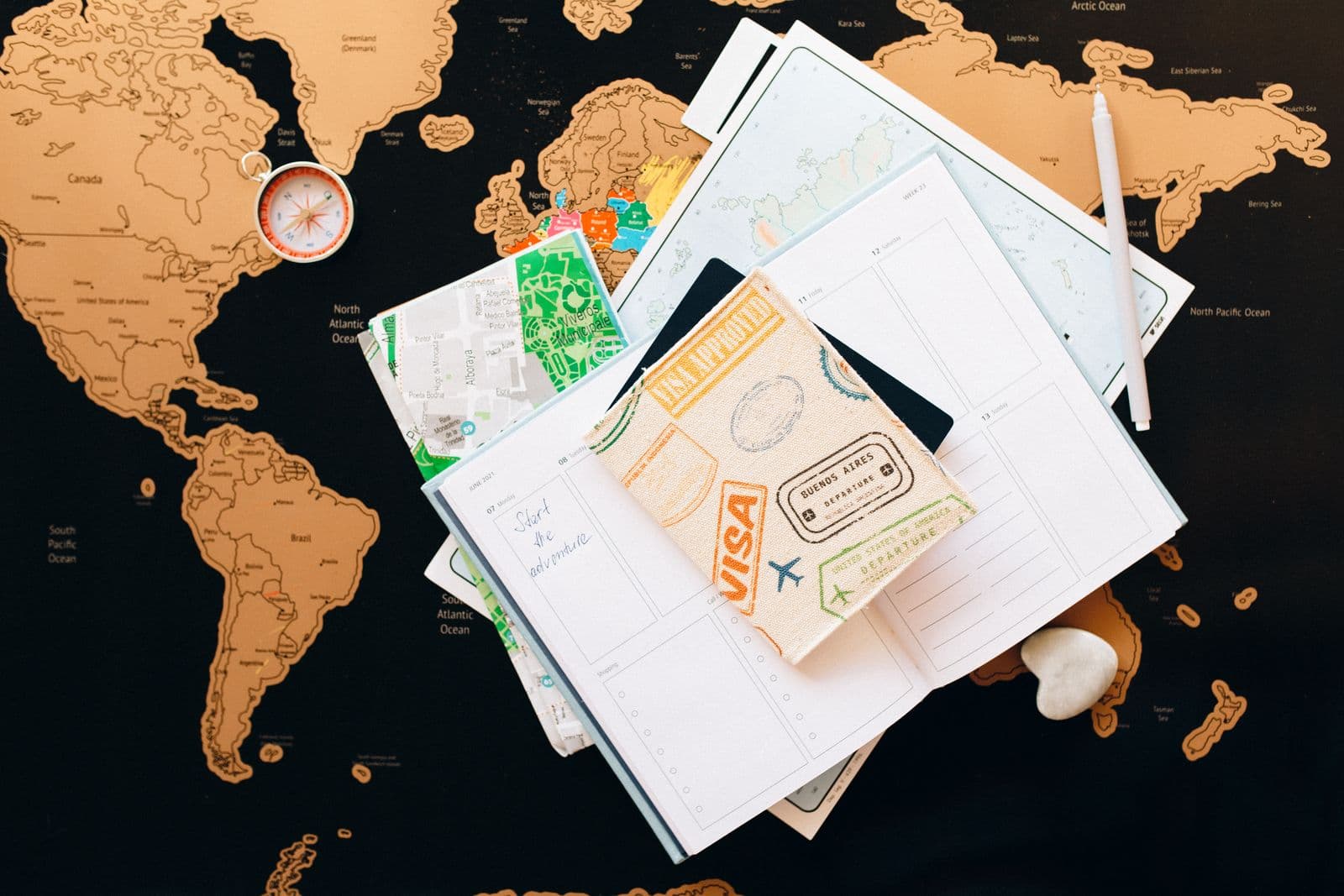 Travel itinerary, map and passport laid out on a planning desk