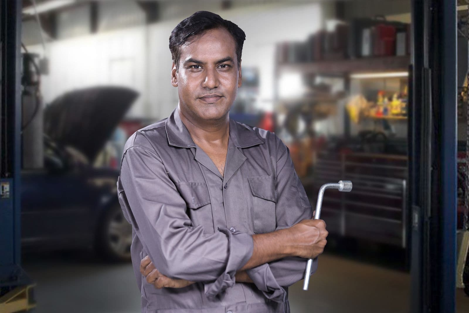Mechanic working on a car in a service centre garage