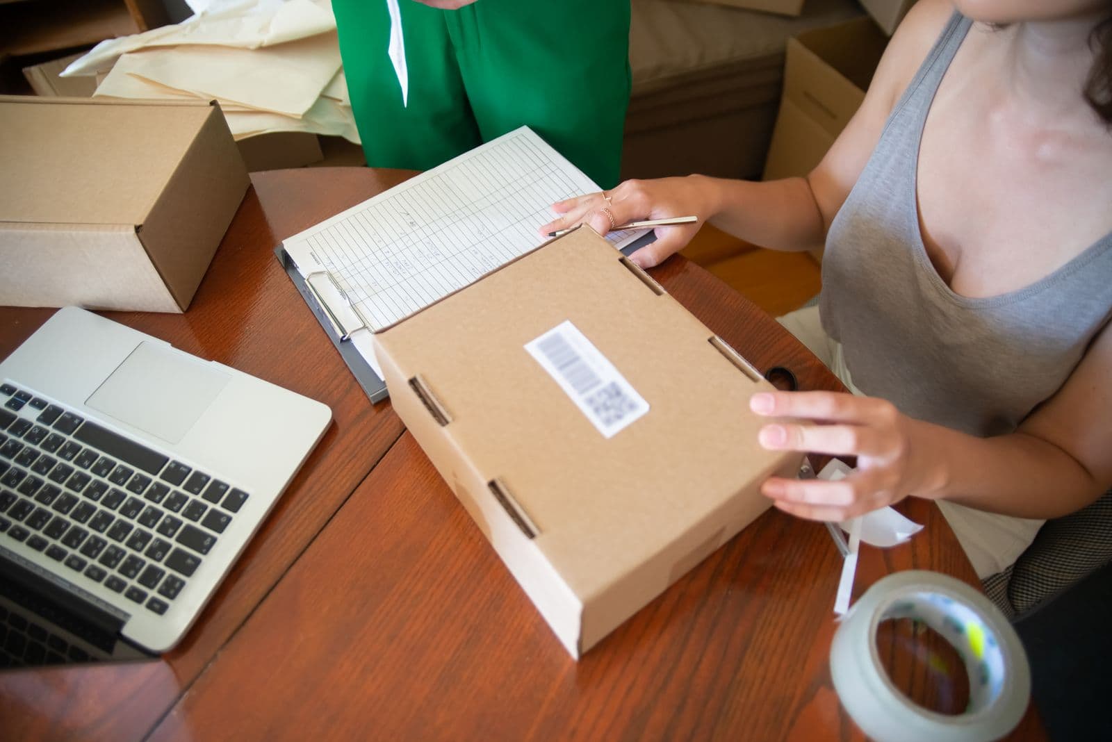 Office staff searching a delivery repository on a laptop