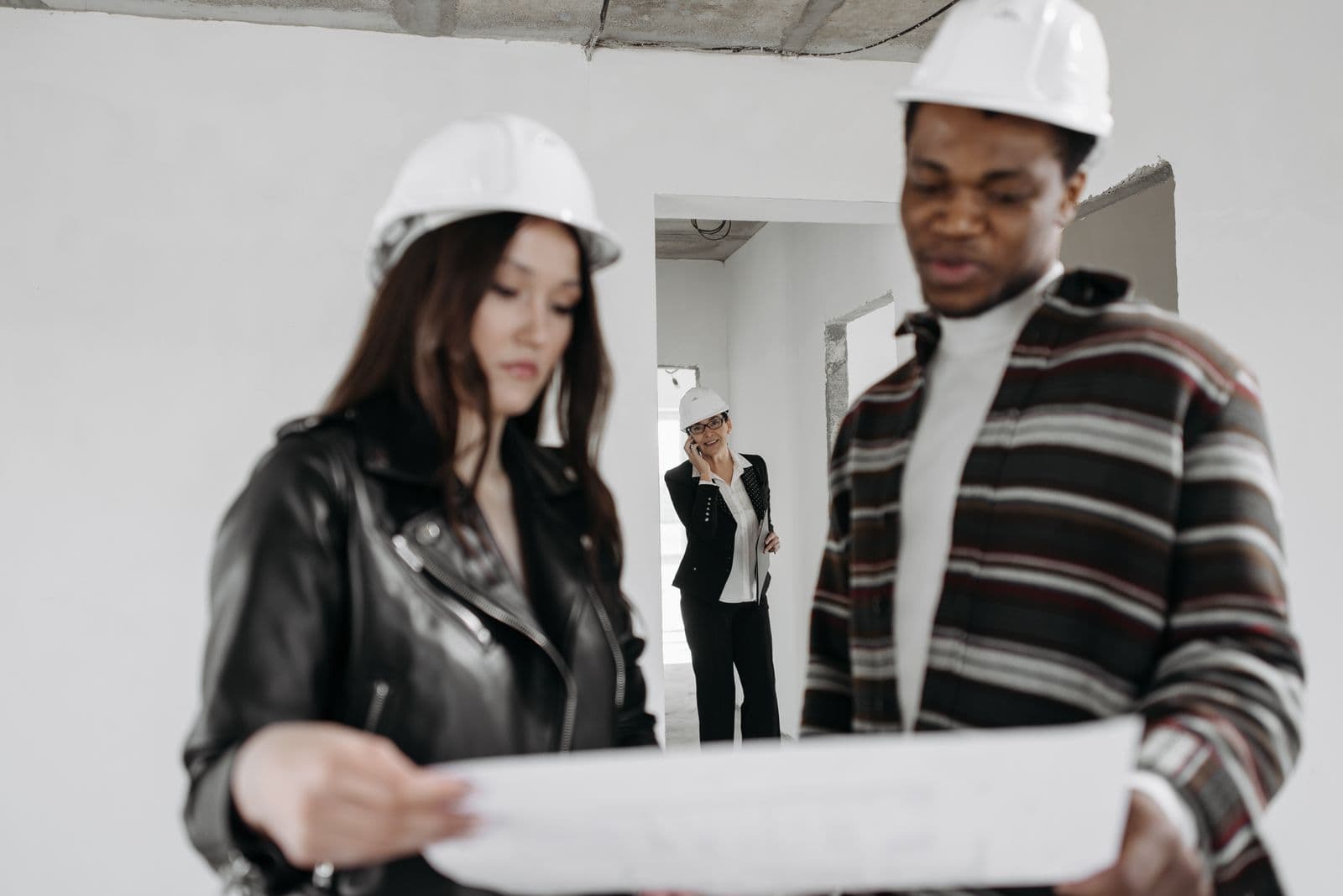 Contractor reviewing project documents and bills on a phone at a site