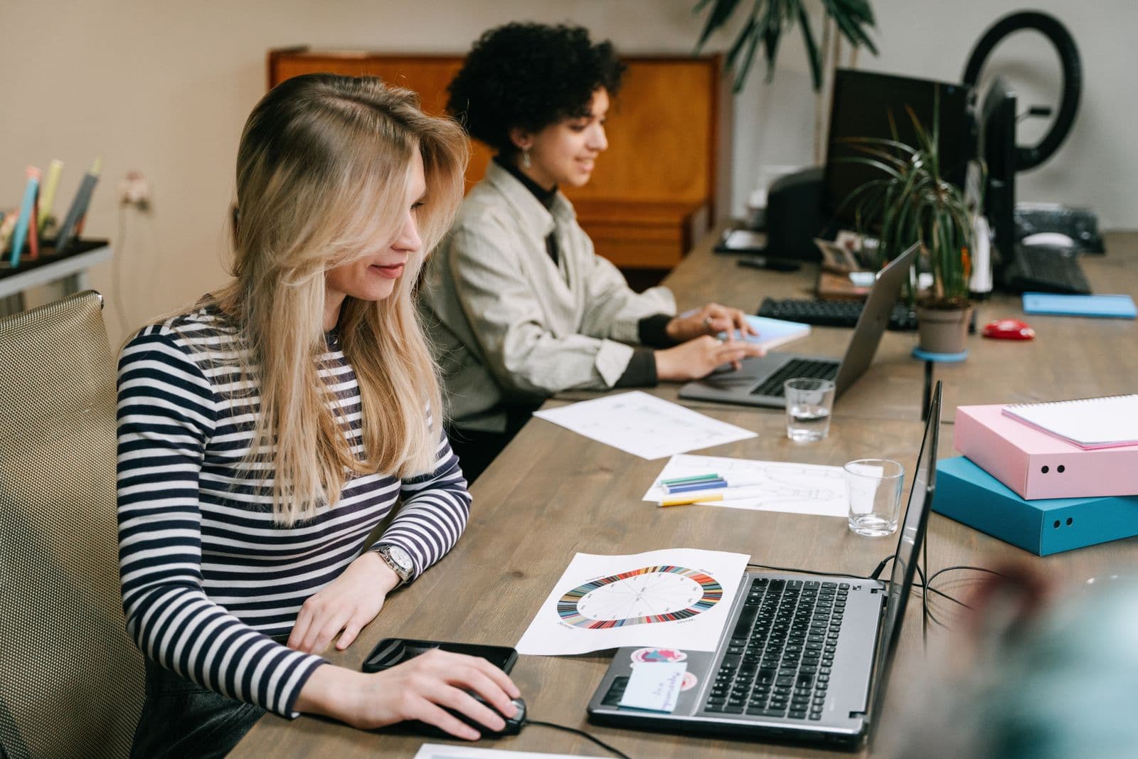 Business team working together at computers in an office