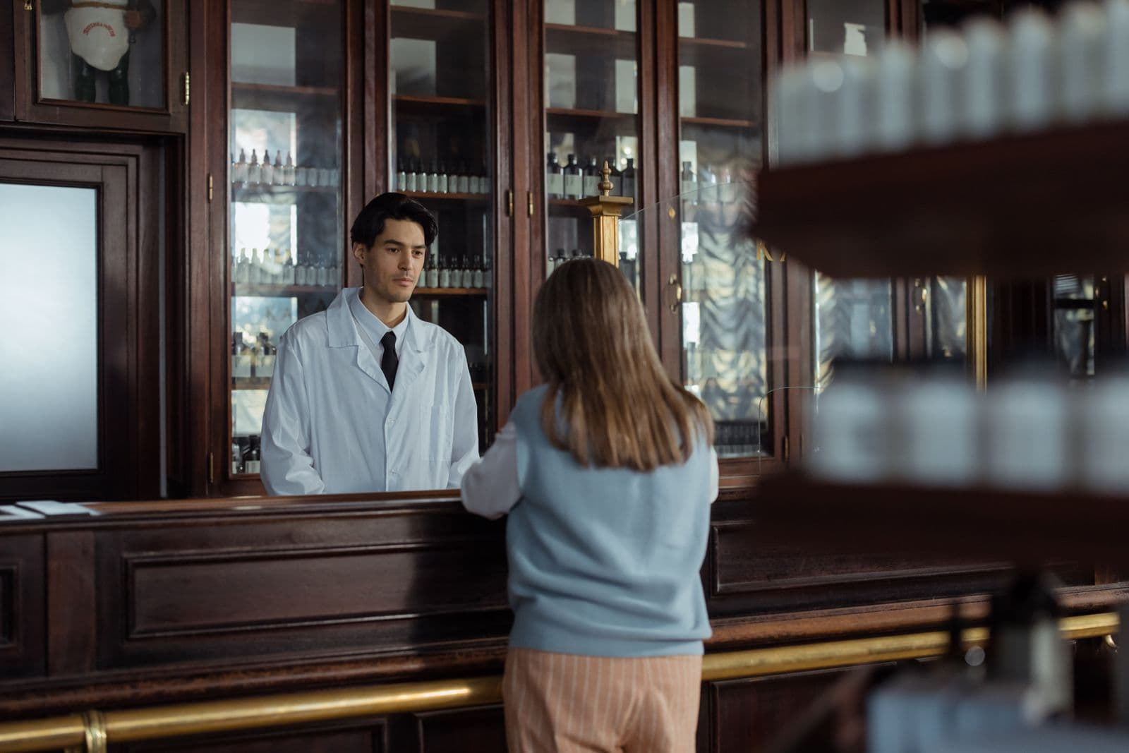 Modern pharmacy shelves stocked with medicine boxes