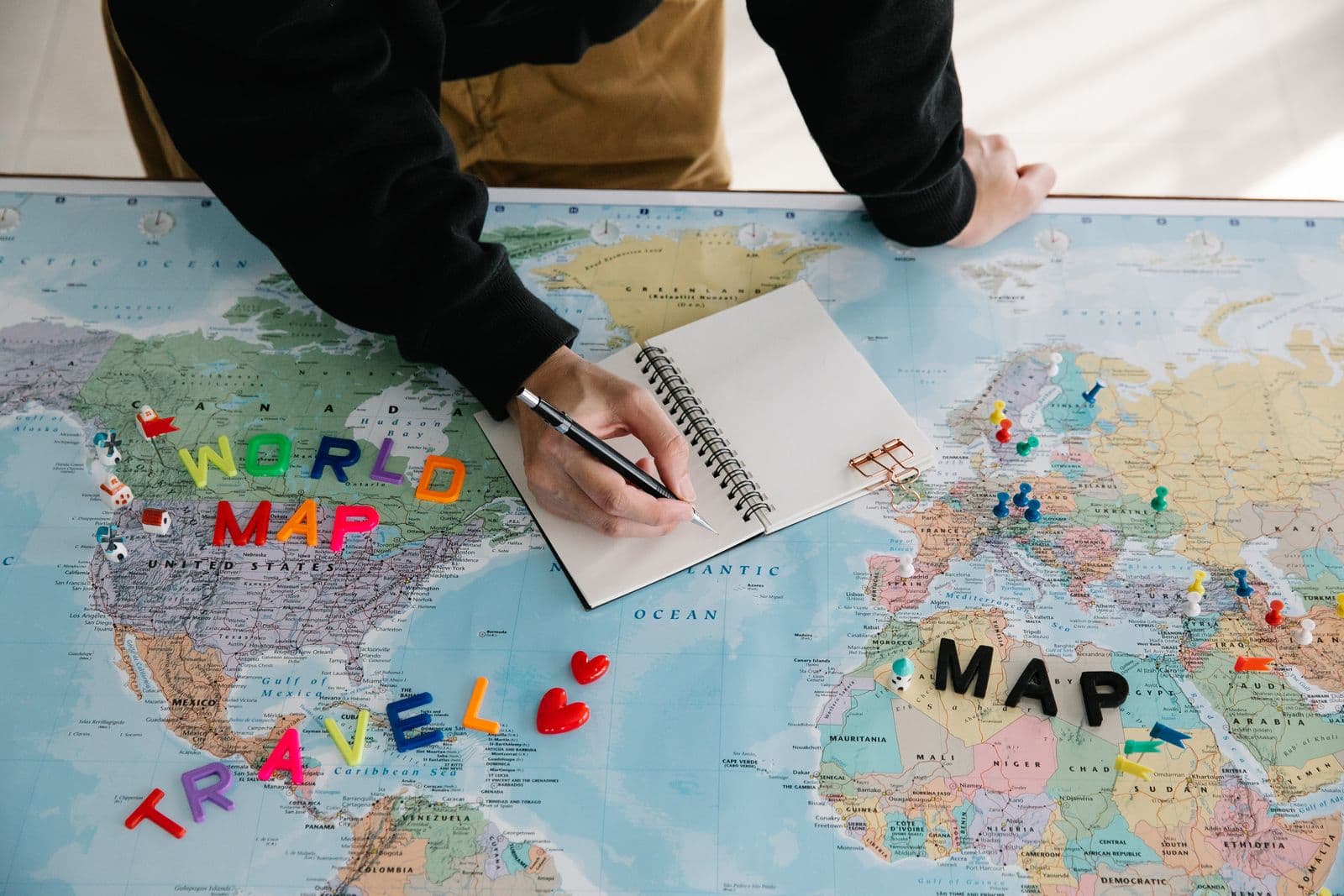 Travel agent at a desk helping a customer plan a trip