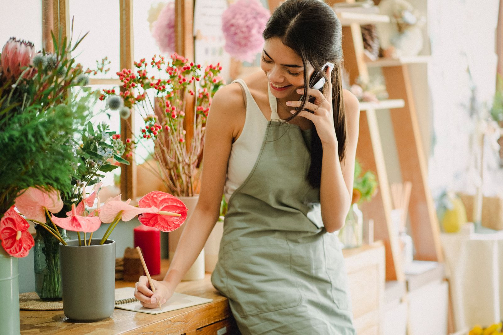 Small business owner using a smartphone in their shop